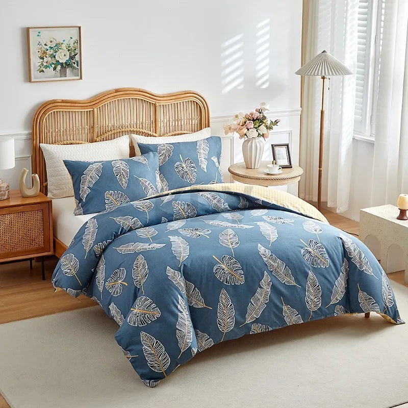 Blue duvet cover set with beige tropical leaf pattern and matching pillowcases