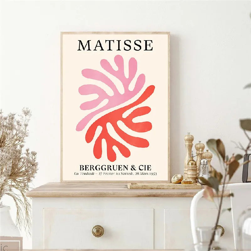 Framed Matisse artwork on a white wall with decorative items below.
