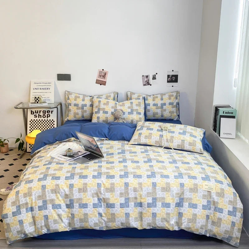 Multi-colour sketch checkerboard duvet cover set with matching pillowcases dressed on a double bed in a modern styled bedroom