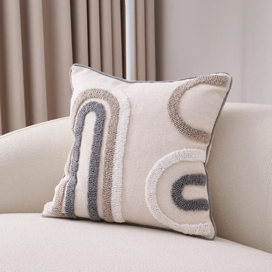 Decorative pillow with abstract patterns on a beige sofa