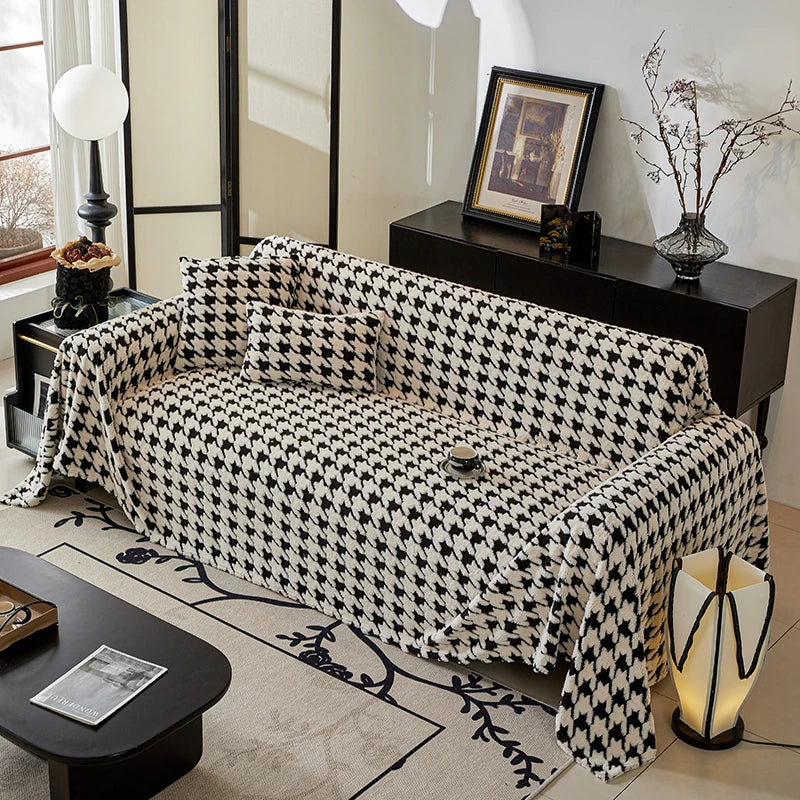 Living room with a black and white patterned sofa, coffee table, and decorative items.