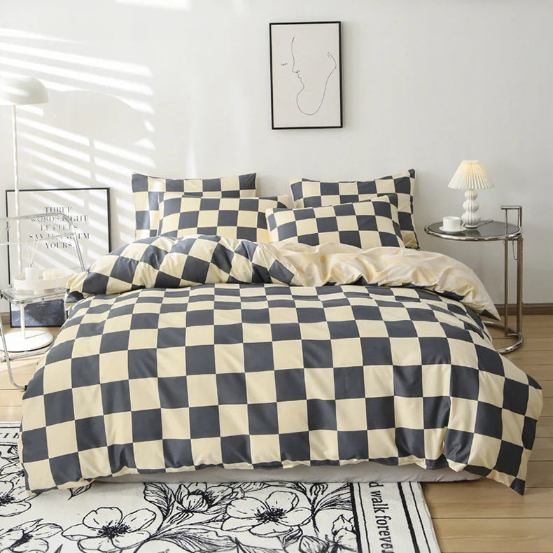 Checkered bedspread on a bed in a room with a lamp and decor.