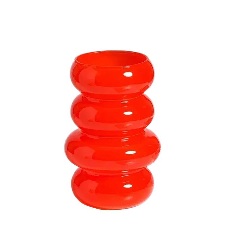 Red cylindrical vase with measurements on a white background