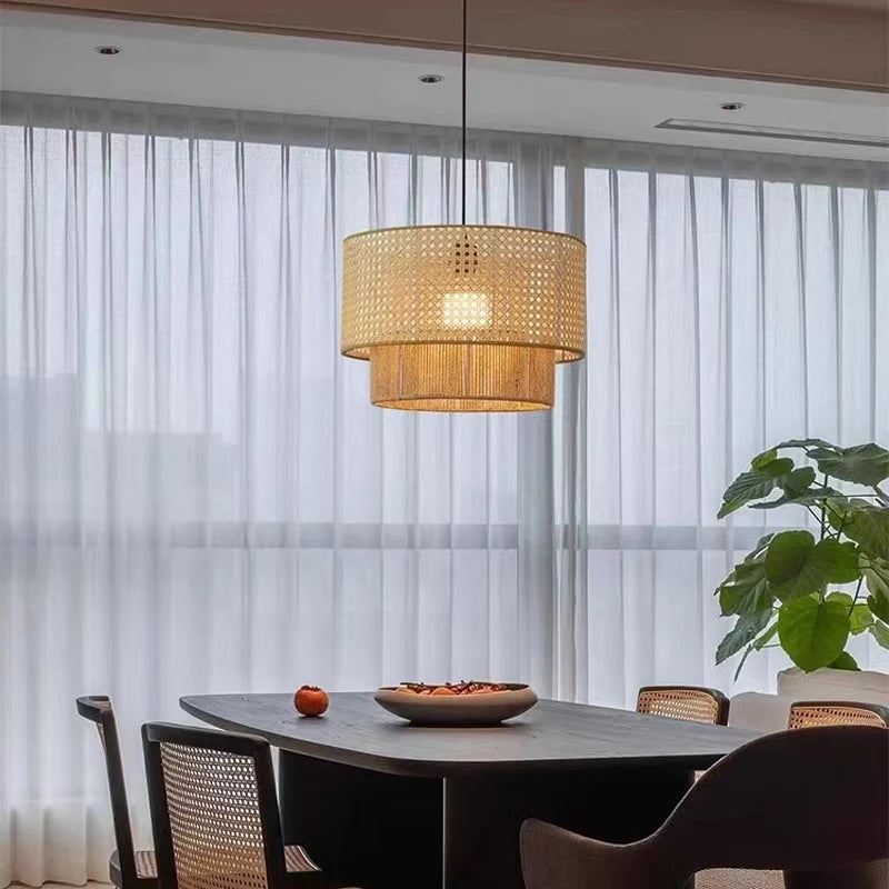 Dining area with a woven pendant light, table, chairs, and a plant in a modern interior setting.