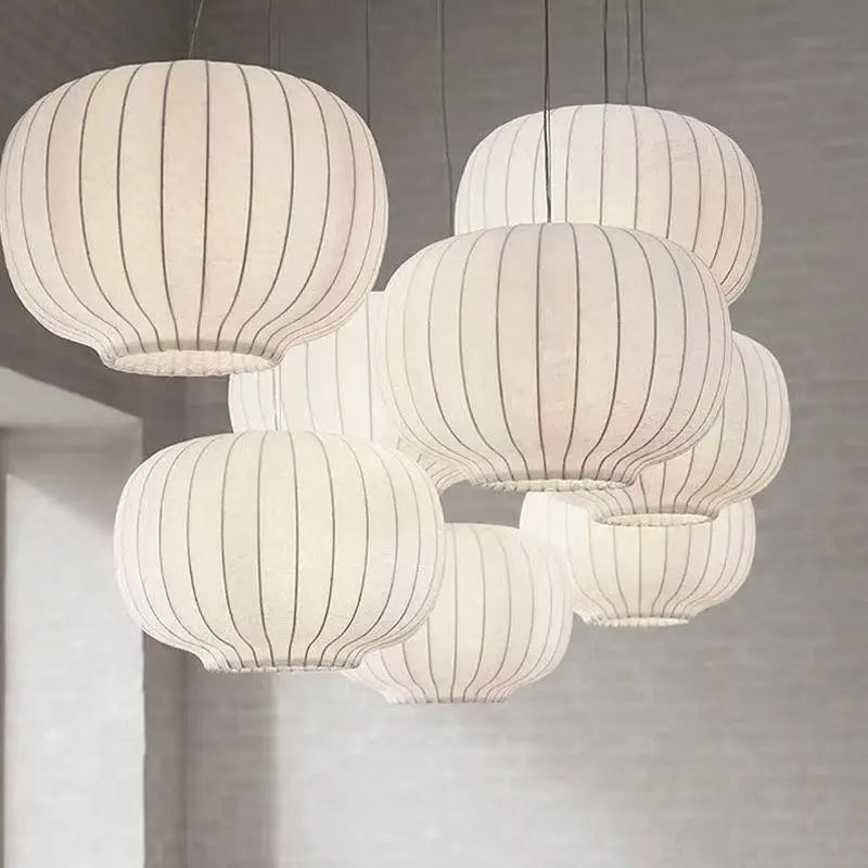Set of hanging pendant lights with ribbed design on a neutral background