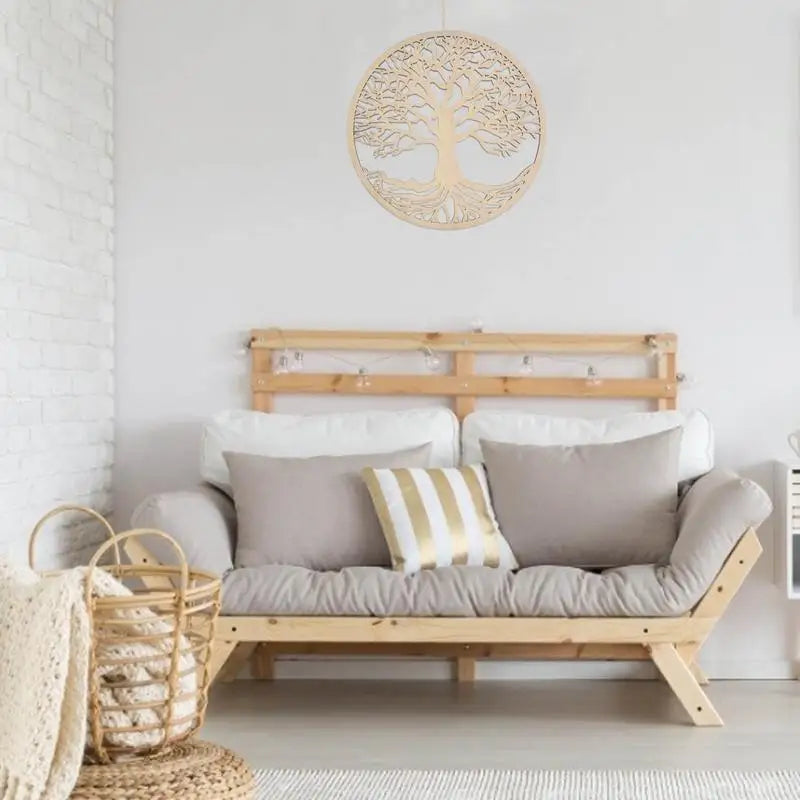 Wooden tree of life on a wall behind a sofa.