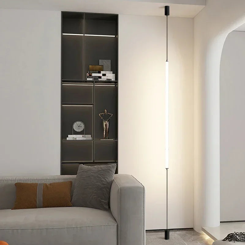 Dual slim Italian floor lamps mounted in a contemporary white living space