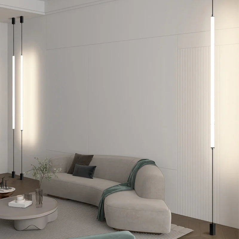 Vertical architectural LED lighting beside a curved modern sofa