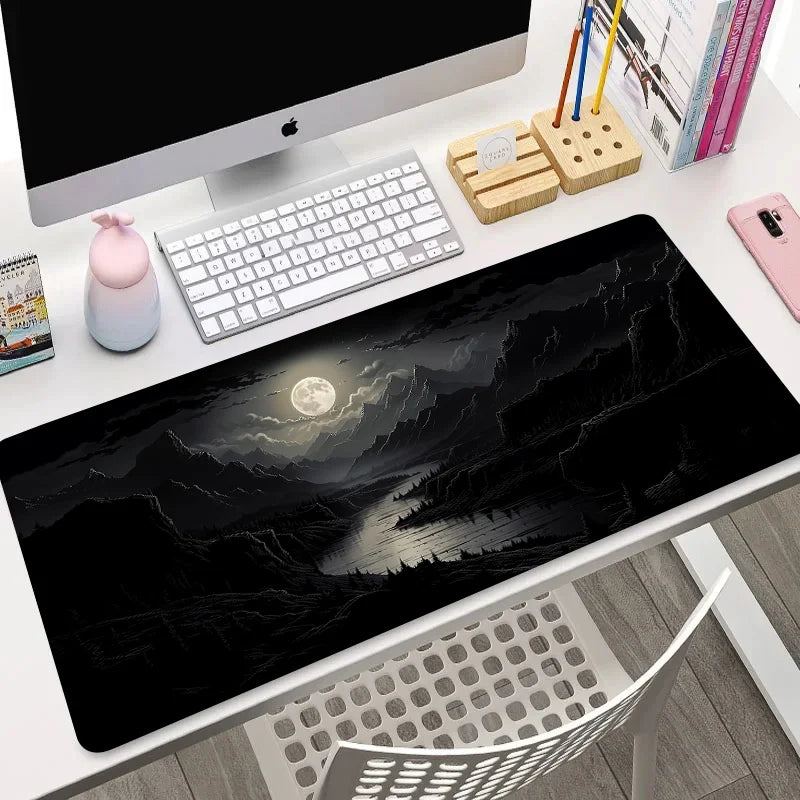 Extended mouse pad with all-black moonlit mountain and river landscape, shown flat and rolled