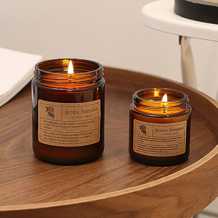 Two glass jars with aroma sensations on a wooden surface.