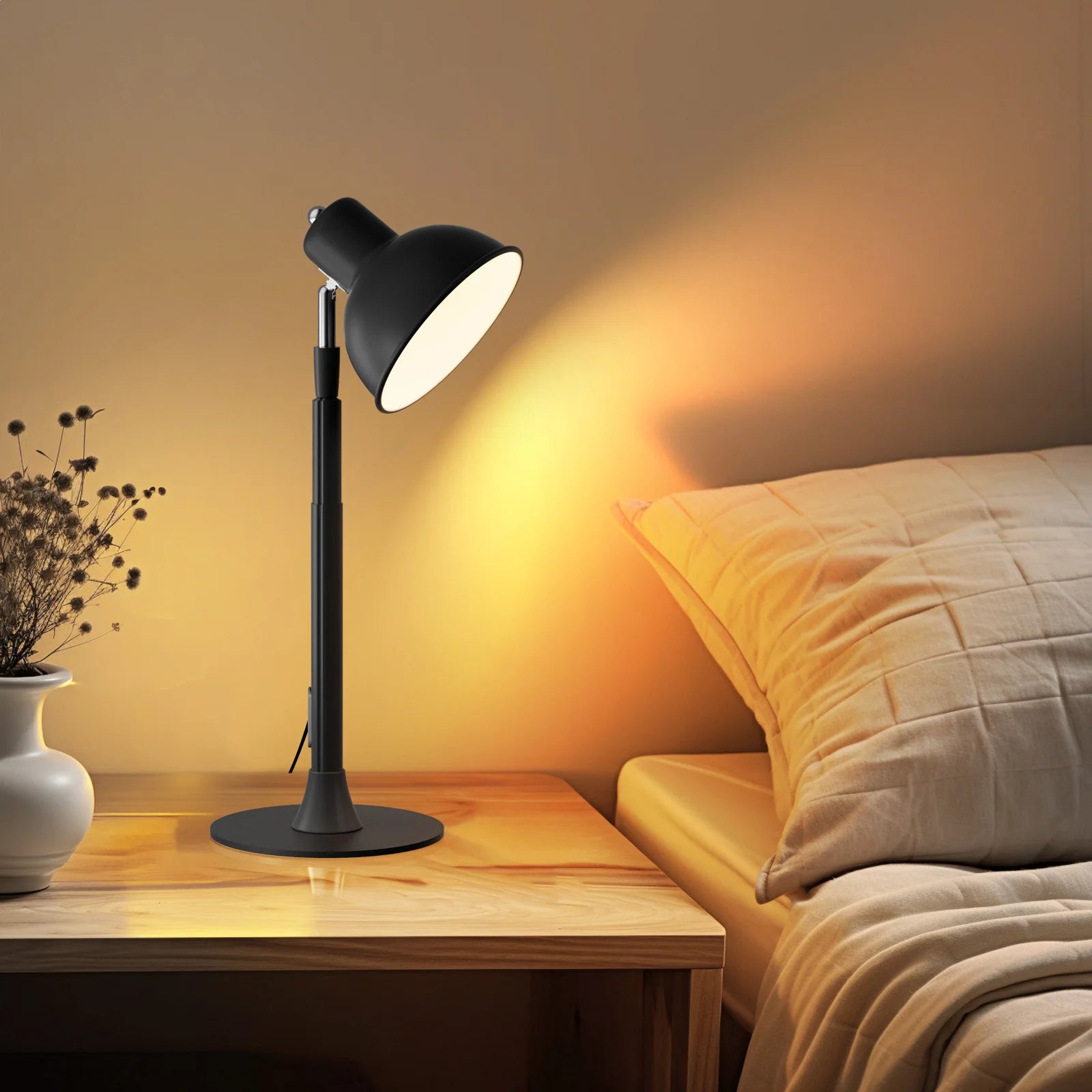 Black table lamp on a wooden nightstand next to a bed with soft lighting.