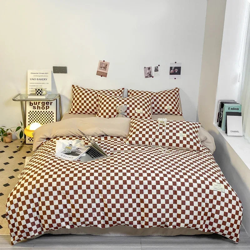 Rust and cream checkerboard duvet cover set with matching pillowcases dressed on a double bed in a modern styled bedroom