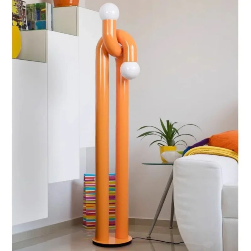 Orange floor lamp with white spherical lights in a modern living room.