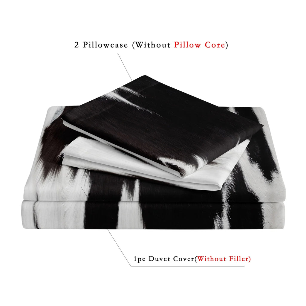 Black and white cow print 3-piece bedding set with matching pillowcases styled on a modern bed