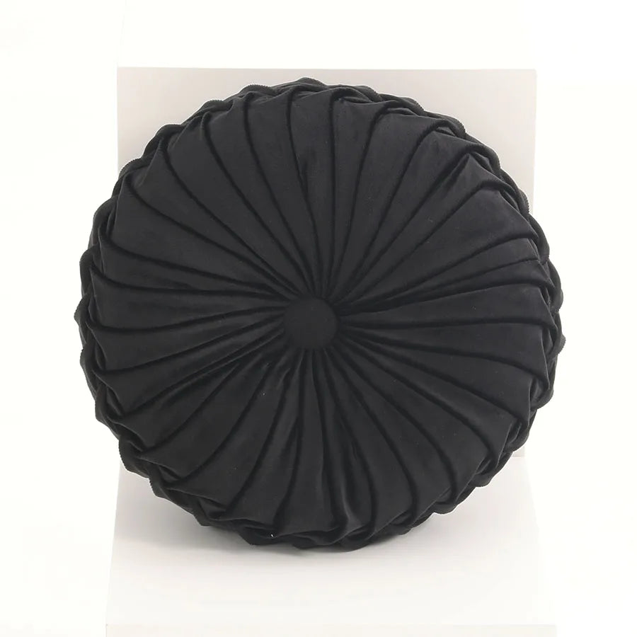 Black round pleated cushion on a white background