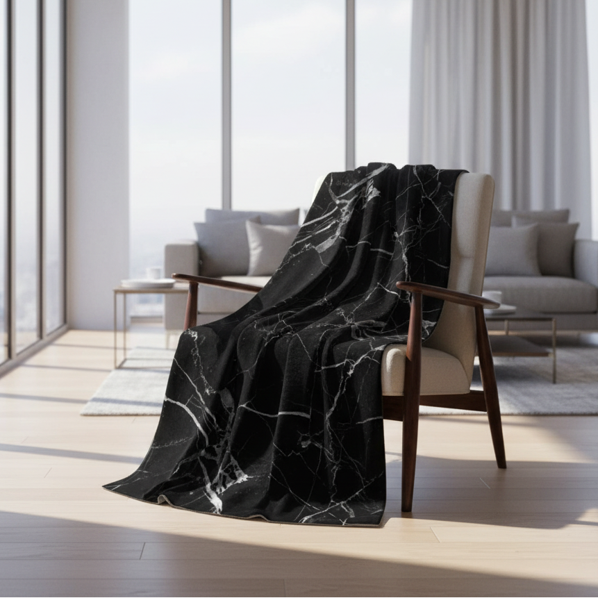 Black marble-patterned blanket on a white background