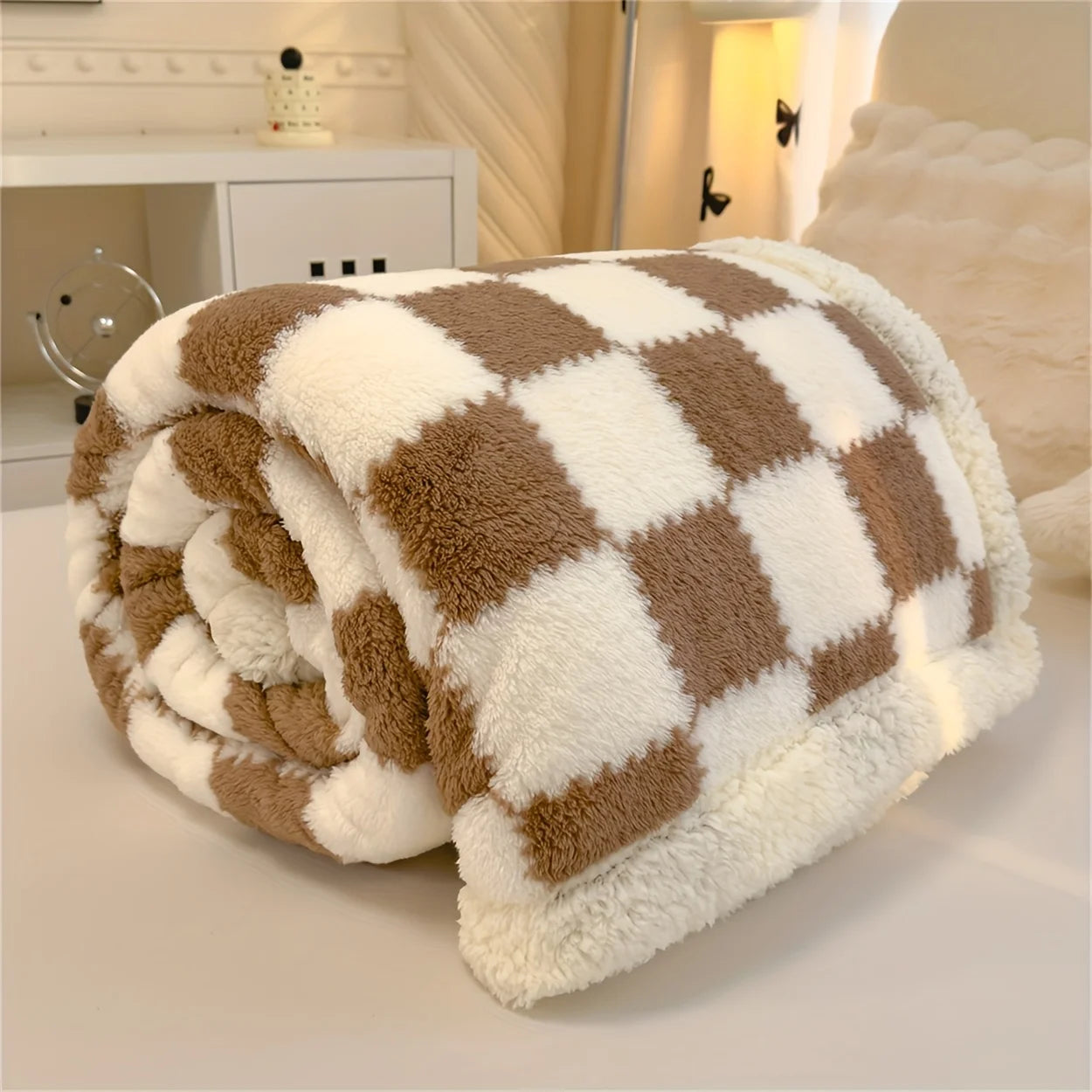 Checkered blanket in brown and white on a bed in a bedroom setting