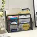 Black mesh desk organizer with various items on a white surface