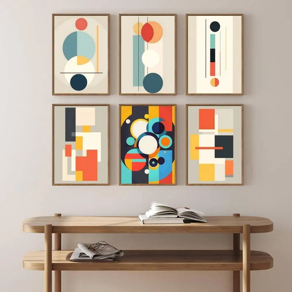 Set of six abstract art prints on a wall above a wooden console table.