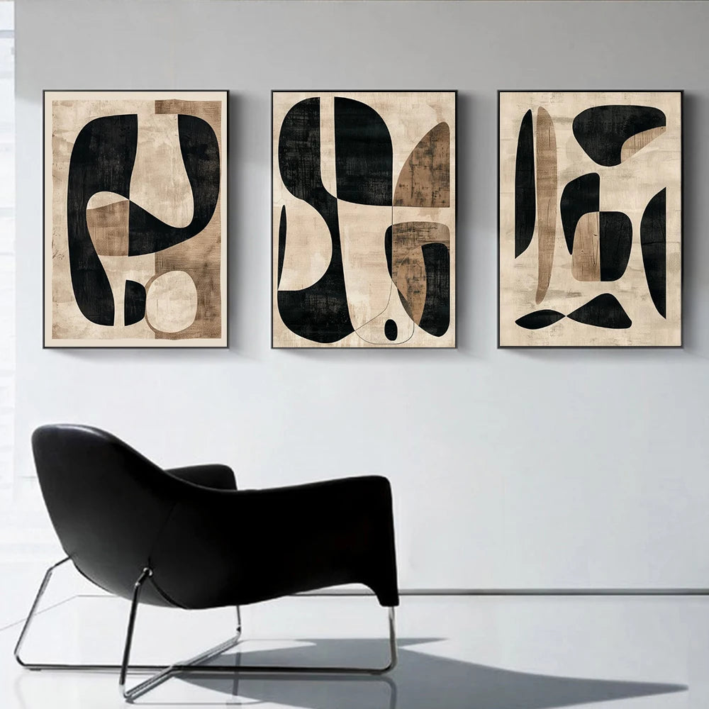 Three abstract art pieces on a wall with a modern black chair below.