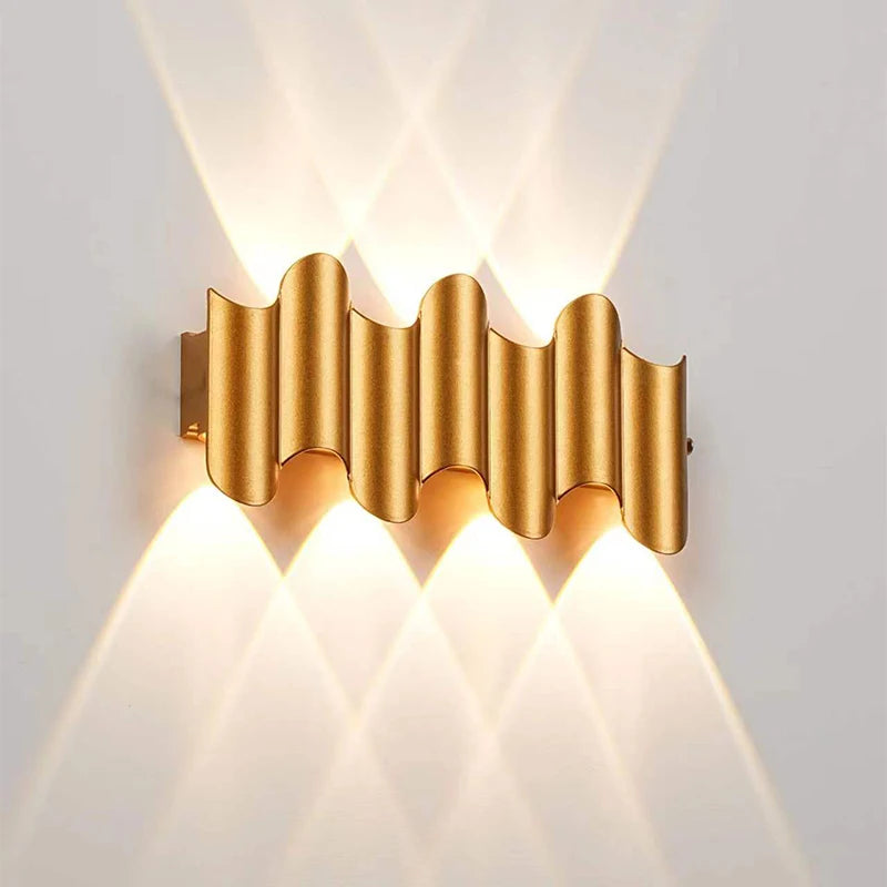 Gold 4-wave wall-mounted LED light with modern ripple design and wide up-and-down glow