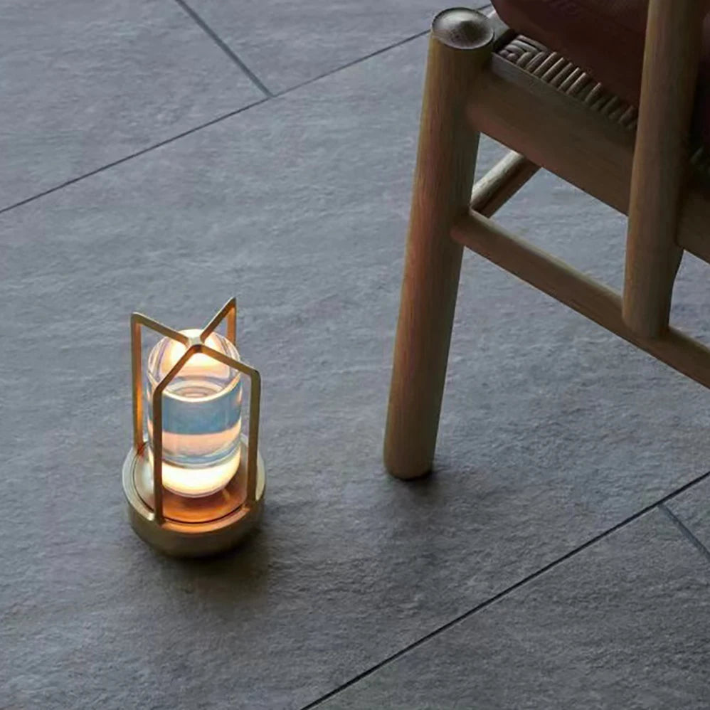 Modern lamp on a stone floor next to a wooden chair