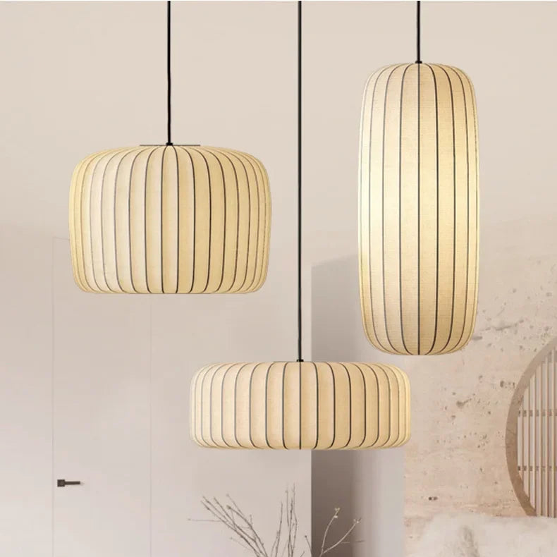 Three pendant lights hanging in a room with a neutral color palette.