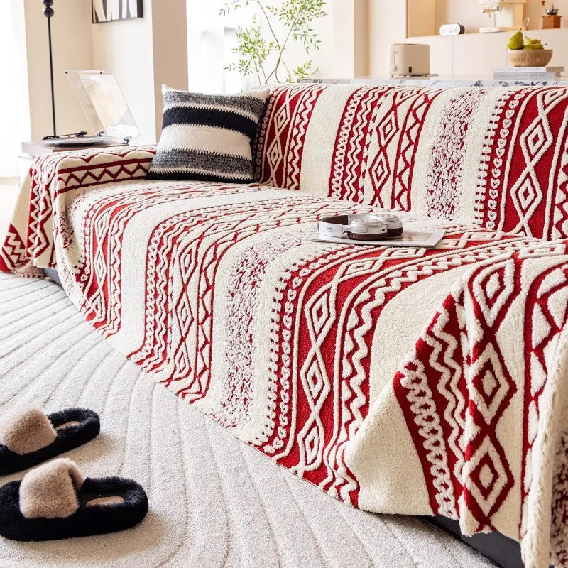 A textured jacquard sofa cover with red and cream geometric tribal diamond patterns.