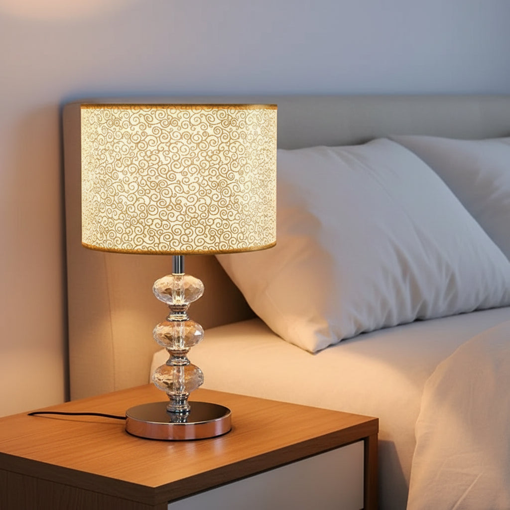 lamp featuring a silver metallic, perforated shade that reflects warm light.