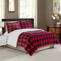 Red and black plaid comforter on a bed in a bedroom setting.