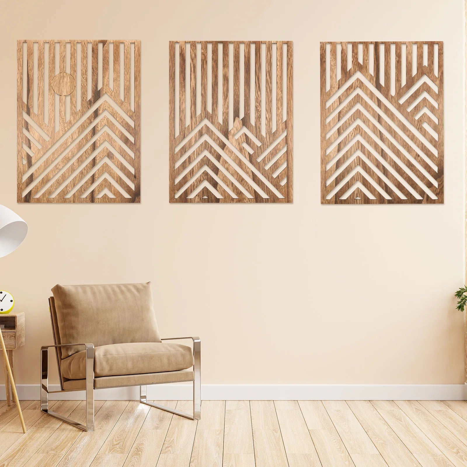 Three wooden wall art pieces with geometric patterns on a beige wall, with a chair and side table in the foreground.