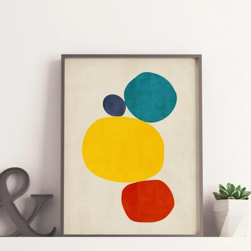 Framed abstract art print with colorful circles on a beige background