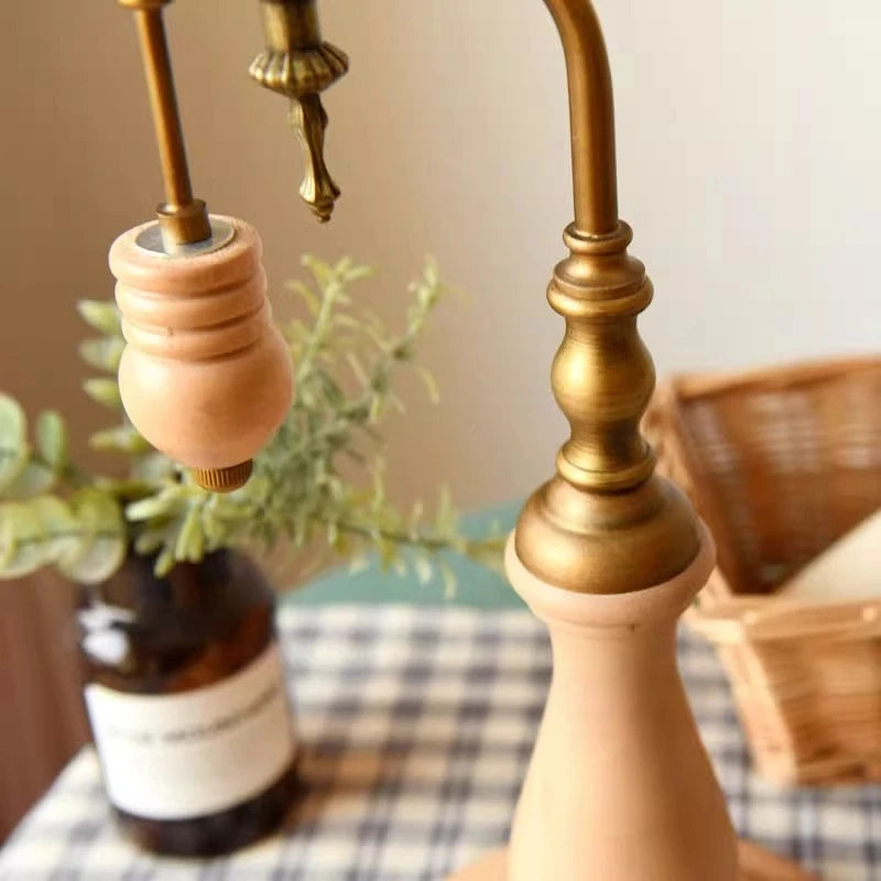 Brass metal lamp frame detail with wooden accent and pull/knob hardware