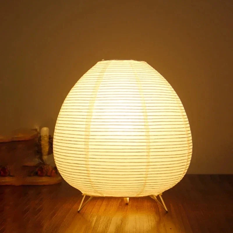 Round Japanese lamp made of rice paper on a wooden floor with a warm glow