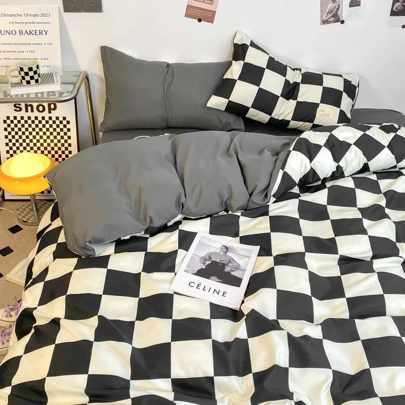Black and white checkerboard duvet cover set with matching pillowcases dressed on a double bed in a modern styled bedroom