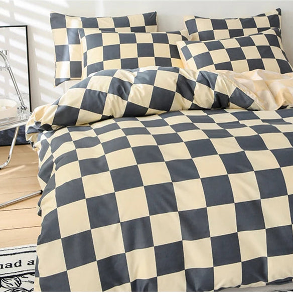 Black and yellow checkered bedding set on a bed in a bedroom setting