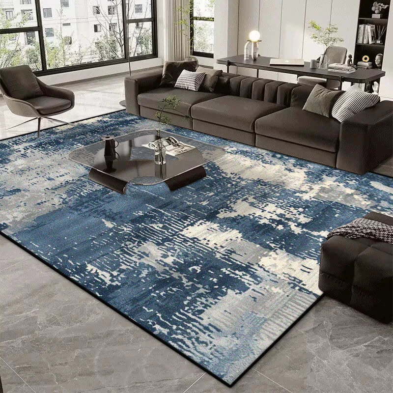 Modern living room with a blue and gray patterned rug, dark sofa, and coffee table.