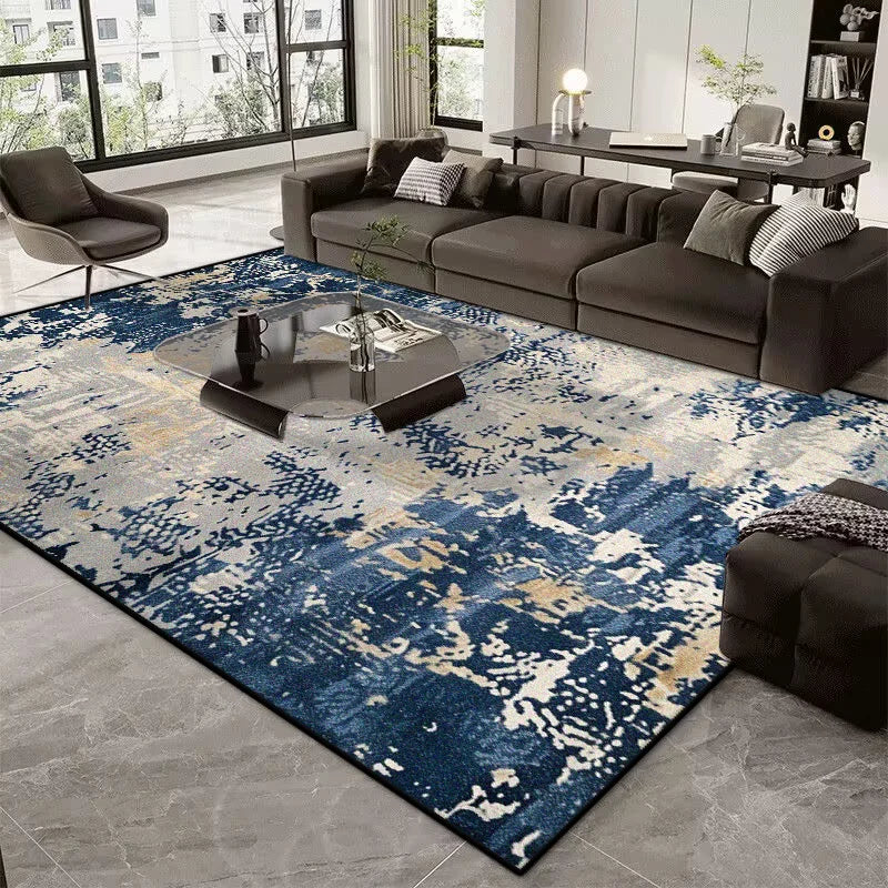 Living room with a blue and gray patterned rug, dark sofa, and coffee table.