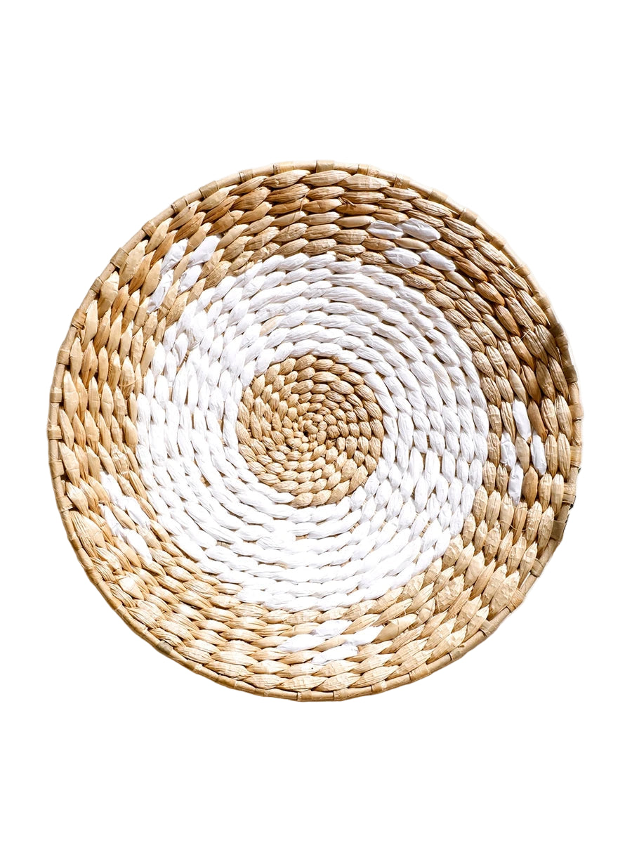 Round woven placemat with white center and beige edges on a light background