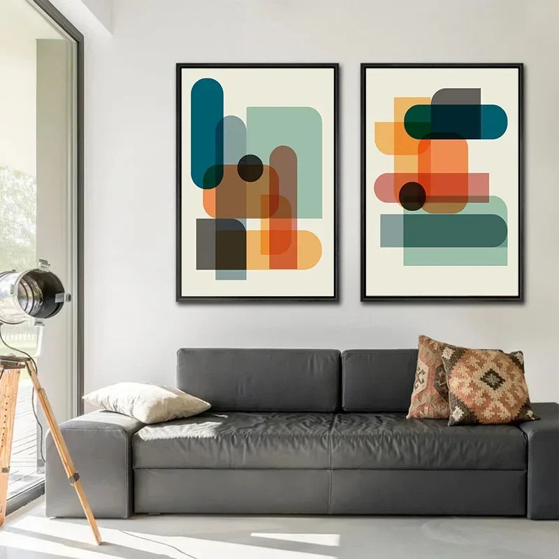 Modern living room with a grey sofa, abstract art on the wall, and decorative pillows.