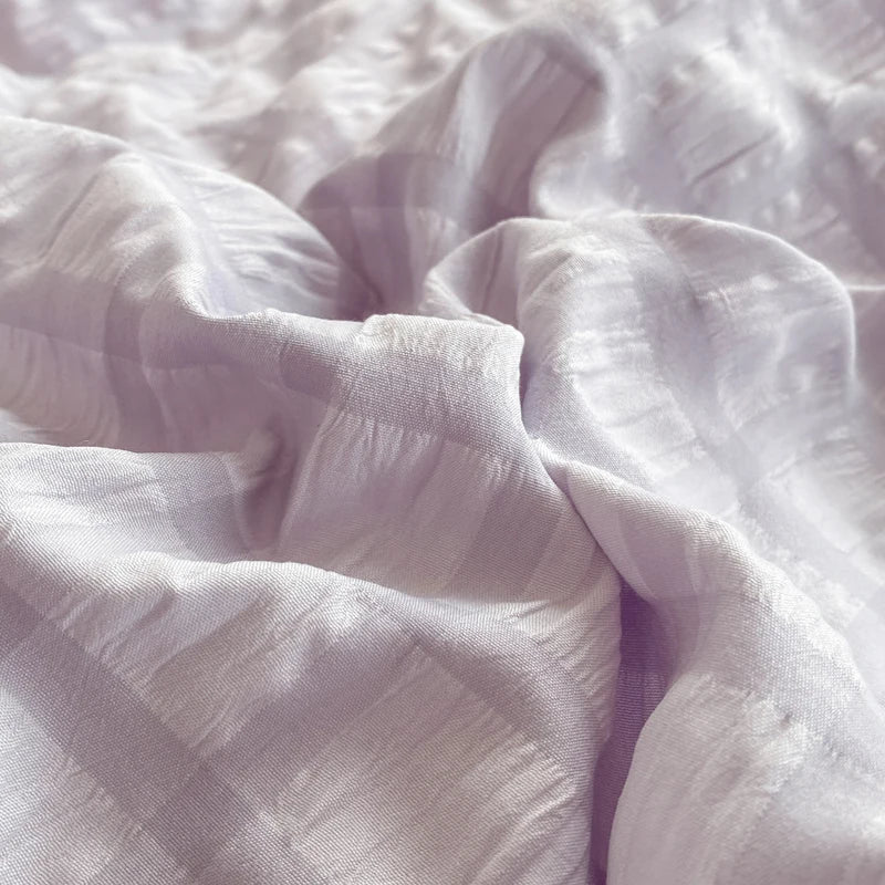 Close-up of light purple fabric with a soft texture