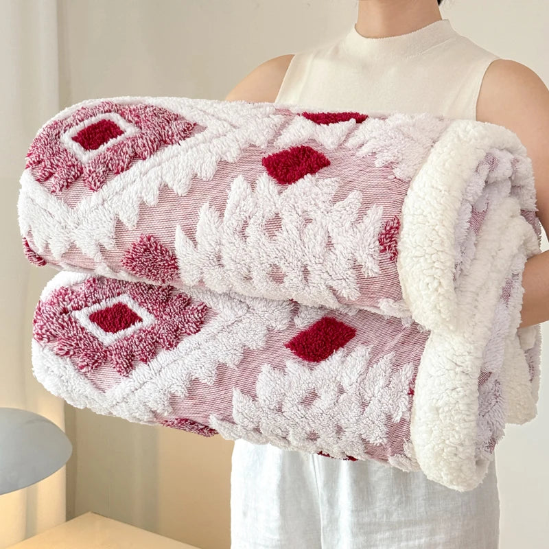 Berry rose and ivory plush blanket spread across a modern bedroom setting.