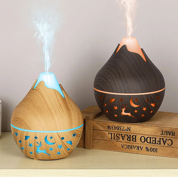 Two wooden diffusers emitting mist on a wooden surface with a crate in the background.