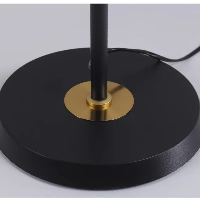 Weighted black circular base with brass accent