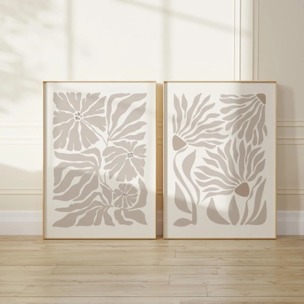 Two neutral abstract botanical canvas prints are together in a calm, minimalist room setting