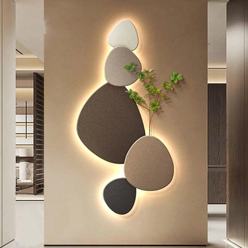 Neutral stone decorative LED wall light with organic shapes, plant detail, and warm ambient glow