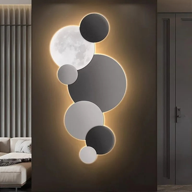 Black and grey moon-inspired LED wall light in a modern hallway