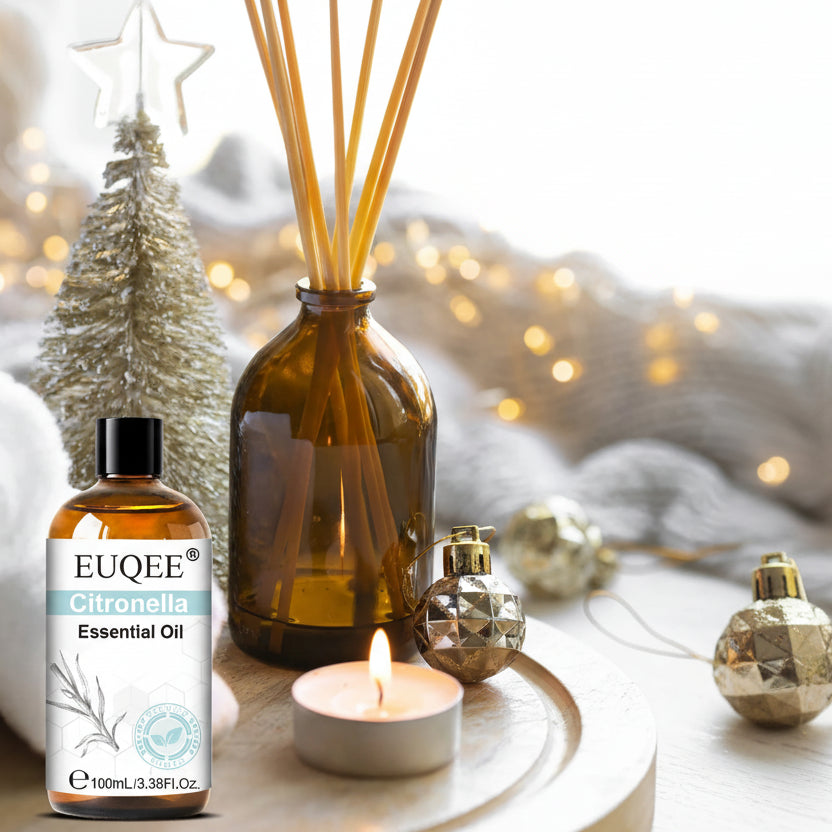 Citronella Essential Oil bottle with diffuser and candle on a decorative surface.