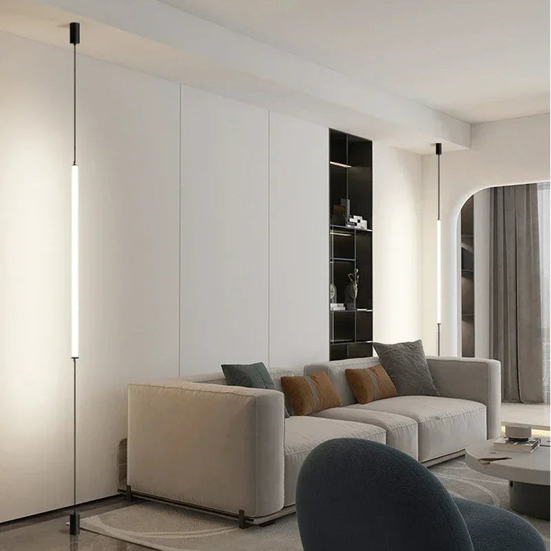Dual slim Italian floor lamps mounted in a contemporary white living space