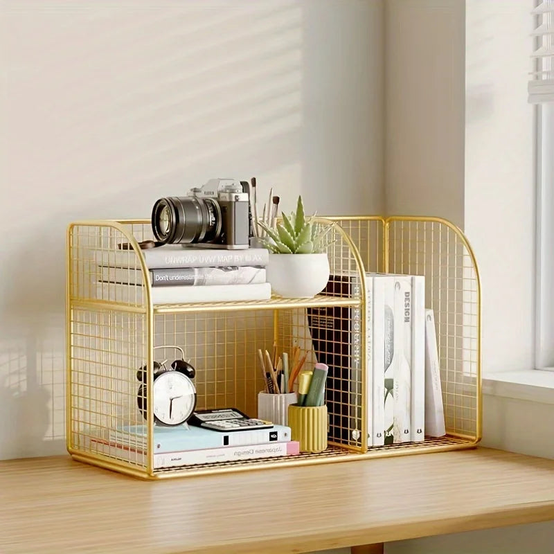 Gold wire desk organizer with books, a camera, and other items on a wooden surface.